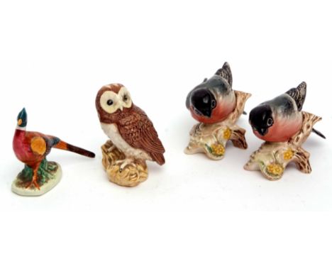 A Beswick model of a pheasant, two Bullfinches, and a further model of an owl (4)