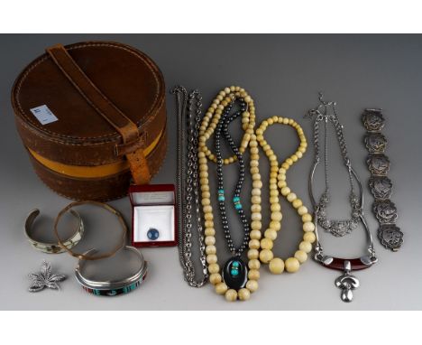 A vintage collar box containing jewellery, including a sterling E. Benally gem set bangle, a white metal filigree Egyptian br