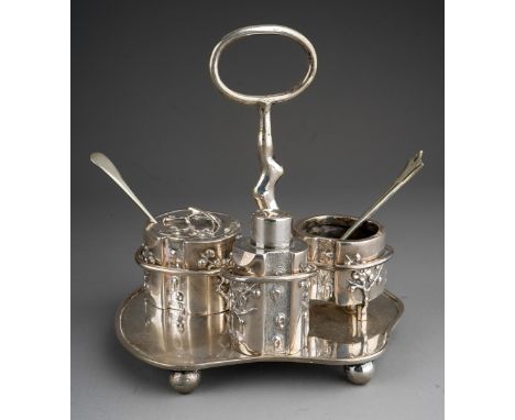 A late 19th / early 20th century Chinese export silver three piece cruet set on stand, the asymmetric frame with trunk and br