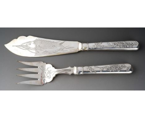 A pair of late 19th / early 20th century Chinese export silver fish servers, the handles repousse decorated with chrysanthemu