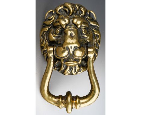 A 19th Century brass door knocker cast as a Lion's head 