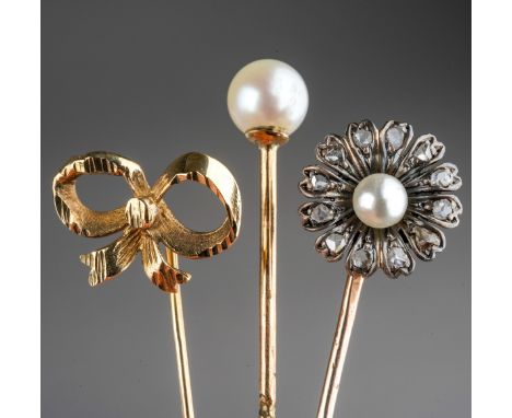 9 ct gold Bow stick pin together with yellow metal and pearl stick pin, yellow metal, pearl and clear stone stick pin. Gross 