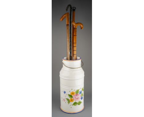 Four assorted walking sticks and canes and a modern Portuguese ceramic stick stand in the form of a milk churn, one of the ca