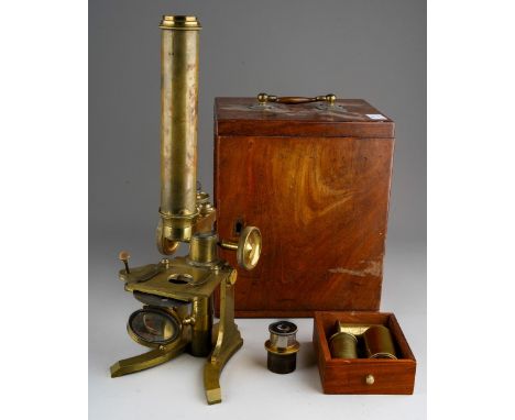 A Victorian mahogany cased brass microscope, un-named, with screw in body tube which lacks any lenses, a unfitted small drawe