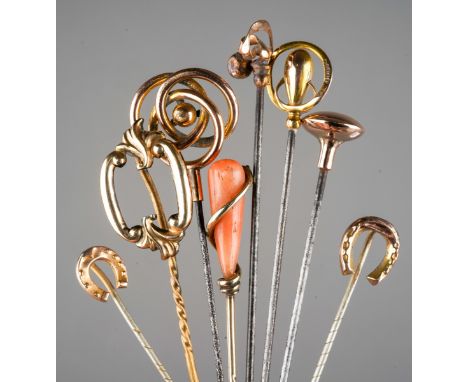 A collection of four gold and yellow metal hat pins and four gold and yellow metal stock pins, including a Charles Horner hal