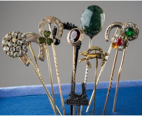 A collection of twelve Victorian and later yellow metal, white metal and base metal stick pins, some set with semi precious, 