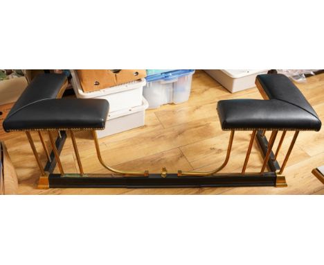20th century extendable black metal and brass club fender, black  leatheret upholstered seat on rounded brass supports. Dimen
