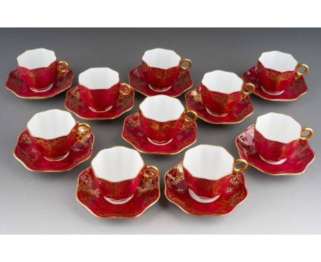 A set of ten Coalport claret and gilt ground way octagonal demi tasse cups and saucers, pattern number 8809 /B, printed and i