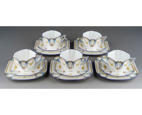 A Shelley Queen Anne shape part tea set in the Garland of Fruit pattern, no. 11705, regd. design 723404, comprising five tea 