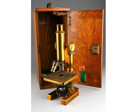 A late Victorian R &amp; J. Beck Ltd of London brass monocular microscope, no.24050, fitted with two objective lenses, in an 
