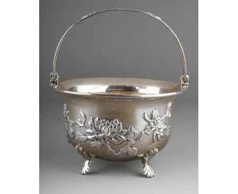 A late 19th \ 20th Century Chinese Export silver sugar bowl with swing handle, the body repousse with trailing prunus flowers