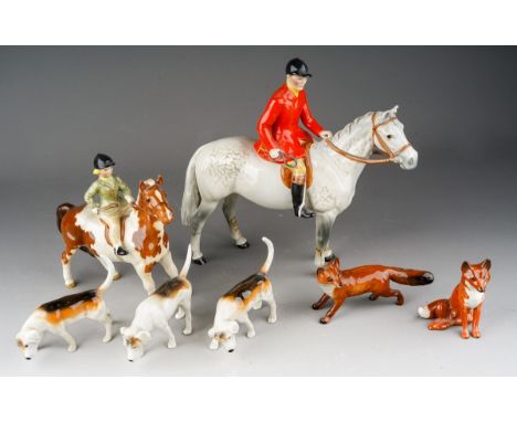 A collection of Beswick Hunting figures comprising Huntsman on grey horse af, girl on pony, two foxes and 3 fox hounds