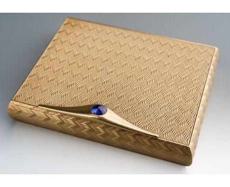 An Asprey &amp; Co. 9ct gold compact case, engine turned detail throughout, inner mirror, clasp set with a sapphire cabochon 