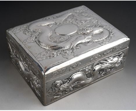 A late 19th / 20th century Chinese export silver rectangular trinket box, pale blue silk lined interior, repousse decorated t