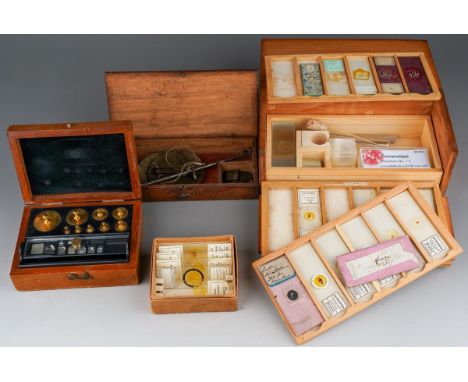 A box containing a small quantity of scientific instruments, including a microscope slide box containing a small quantity of 