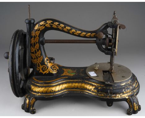 A Victorian cast iron Jones swan neck table top manual sewing machine, figure of eight shaped base, on four scrolled feet, se