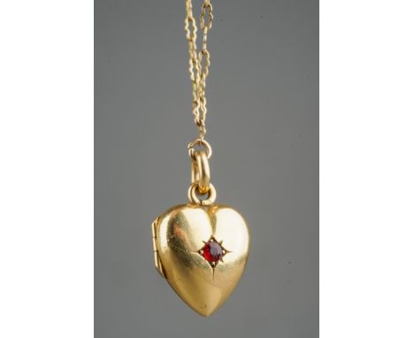 18 ct gold hear locket set with a ruby on a rolled gold chain, gross weight of heart locket 4.8g