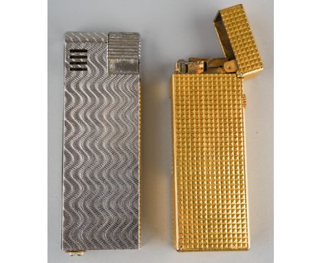 Alfred Dunhill; A Dunhill gold plated rollagas pocket cigarette lighter, engine turned case together with another similar chr