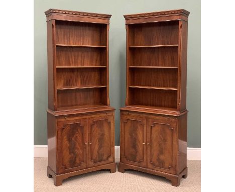 PAIR REPRODUCTION MAHOGANY BOOKCASE CUPBOARDS, dentil moulding to the cornice, four shelf open tops, central slides, twin bea