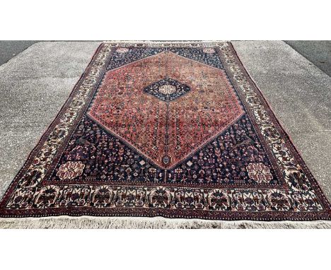 PERSIAN RED GROUND WOOLEN RUG, traditional design large central diamond block, bird and animal pattern corners, continuous tr