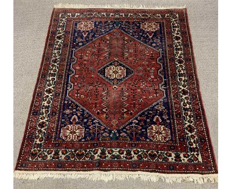 EASTERN WOOLEN RED AND BLUE GROUND RUG, traditional multi pattern central diamond and corner motifs, multi bordered edge, tas