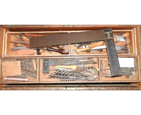 A carpenter's tool chest and tools, including a large square, a wooden and brass brace, boxwood chisels, etc.Charles Woolveri