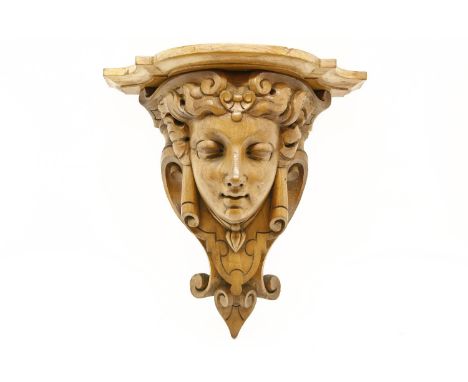 A carved walnut wall bracket, with masked detail 38cm high