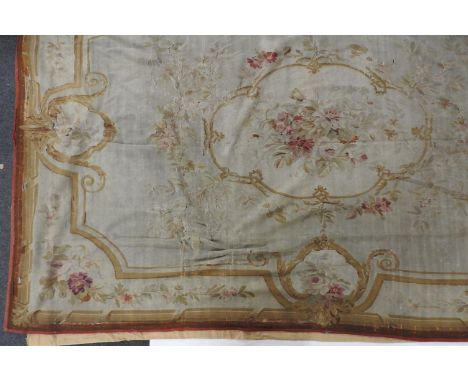 A large 18thC Aubusson tapestry decorated with floral sprays, approx 330 x 240cm