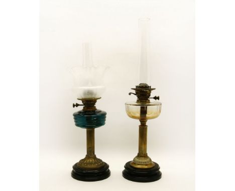 A Victorian cast metal oil lamp with blue glass reservoir and etched glass shade, and one other (2)