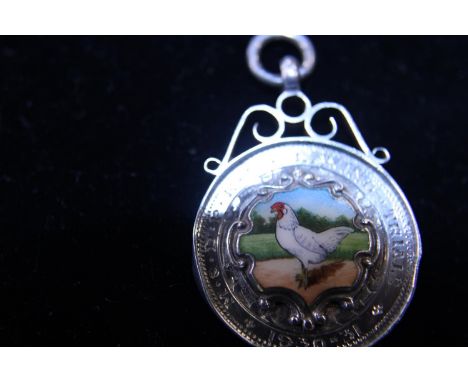 A 1930's silver fob with enamel and gold insert 