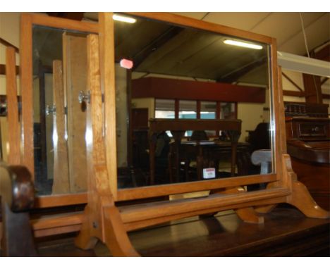 A pair of early 20th century light oak swing toilet mirrors 