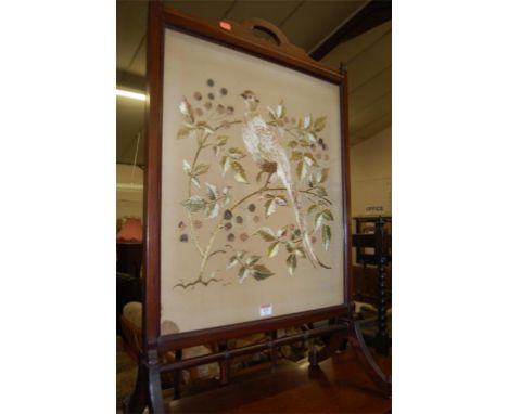 An Edwardian mahogany framed and floral silkwork inset fire screen