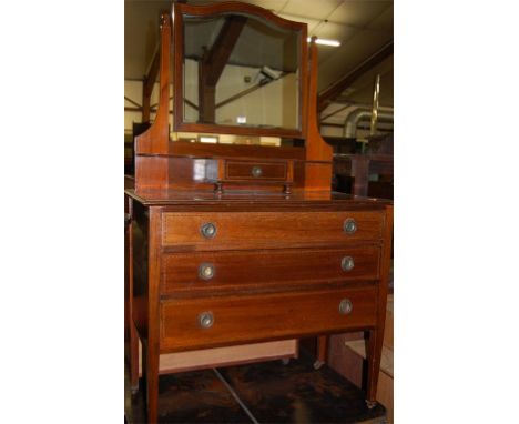 An Edwardian walnut and chequer strung mirror back three drawer dressing chest