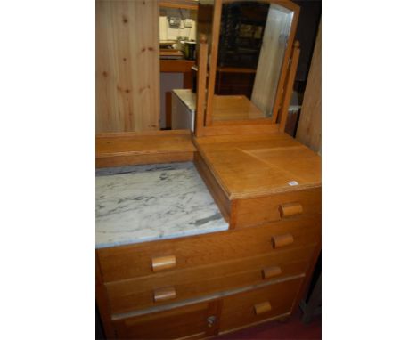 A 1930s light oak and part white marble lopped swing mirrorback dressing chest 