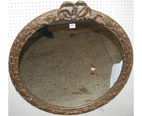 A modern French style giltwood circular wall mirror of good size, having ribbon surmount and trailing acanthus leaf decoratio
