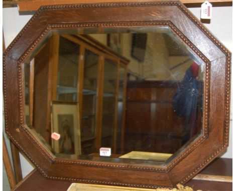 A beaded oak octagonal bevelled wall mirror and one other similar (2) 