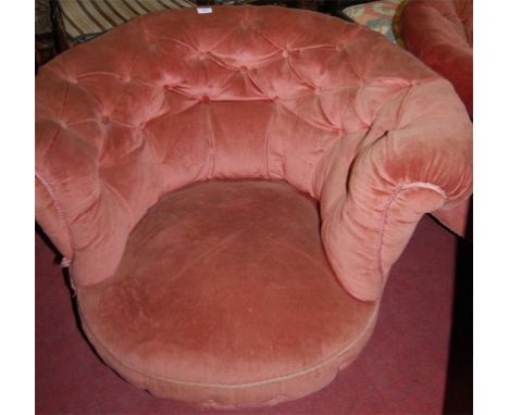 A pair of Victorian mahogany framed and pink button back upholstered tub chairs, raised on turned supports