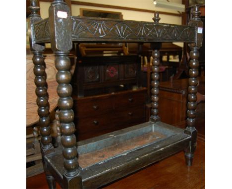 An early 20th century line carved oak and bobbin turned two division stickstand