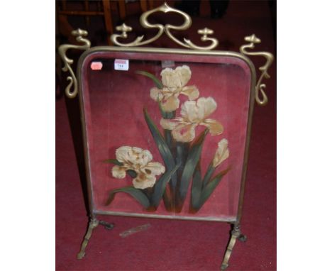 An Art Nouveau brass and mirrored glass inset fire screen