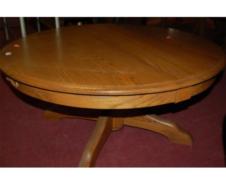 A contemporary light oak circular fixed top low occasional table