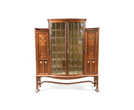 the bowed centre enclosed by 21 pane glazed doors, flanked by cupboards with marquetry and mother-of-pearl inlaid decoration1