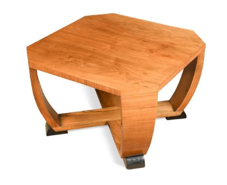 the square canted top raised on four supports which curve to meet a cross stretcher, with ebonised feet, the whole veneered i
