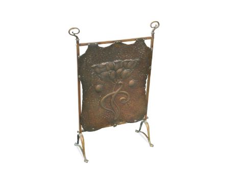 the shaped repoussé decorated rectangular panel embossed with stylised floral motif within a brass frame78 x 52cm