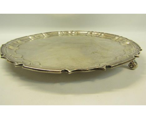A contemporary silver salver with a raised border, supported on three scrolling feet, makers mark for William Hutton &amp; So