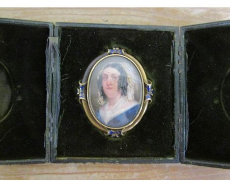 Unsigned 19c oval miniature portrait of a lady on ivory, framed and glazed, in a brass and enamel mounted oval frame in foldi