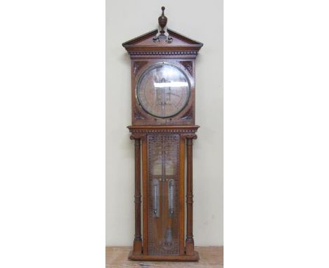 A late 19c Royal Polytechnic Barometer by Davis &amp; Co in oak case with broken arch pediment with central finial.  The 24cm