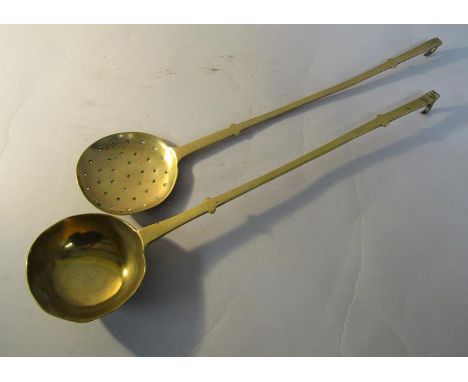 An early 19c brass ladle together with a skimmer, both 45cm l. 