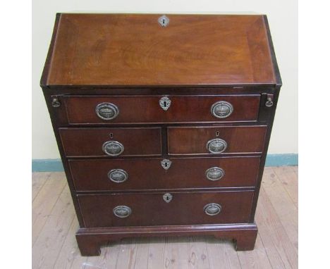 A George III figured mahogany bureau with fall front and fitted interior over two short and three long drawers with bracket f