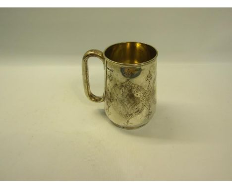 A Victorian silver tankard chased with decorated cartouche, makers mark for Henry Wilkinson &amp; Co, London 1877, 9.5oz t, 1