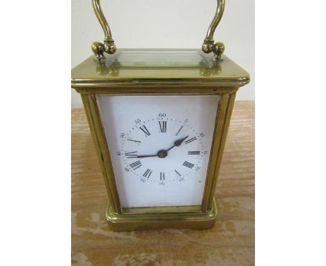 A late 19c French carriage timepiece in glazed brass 'Obis' type case with white enamel dial with Roman numerals and outer Ar